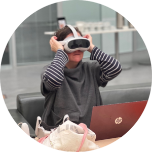 Researcher wearing a virtual reality headset at a laptop