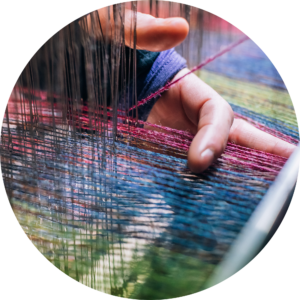 Hands weaving Harris Tweed on a loom